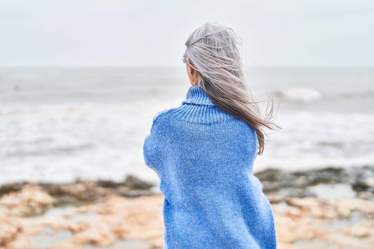 Older woman looking out at the ocean. 