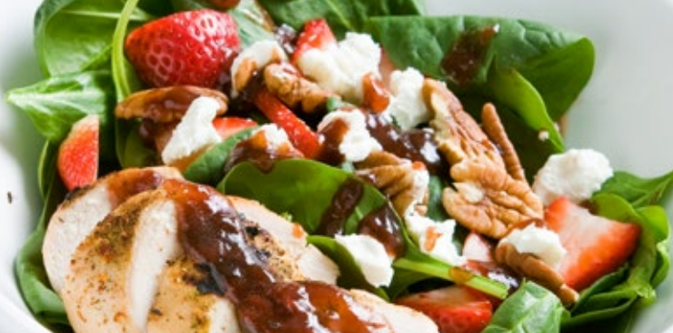 Spinach salad with chicken, strawberries, walnuts, and feta cheese