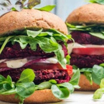 Double hamburger with leafy greens in the bun