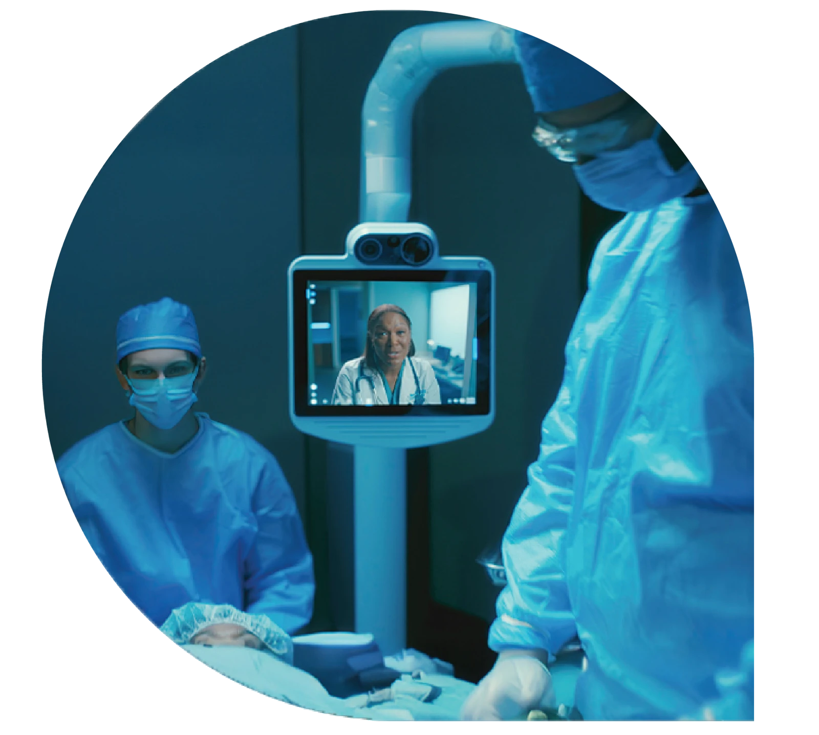 Surgeons operating while a doctor appears on a monitor