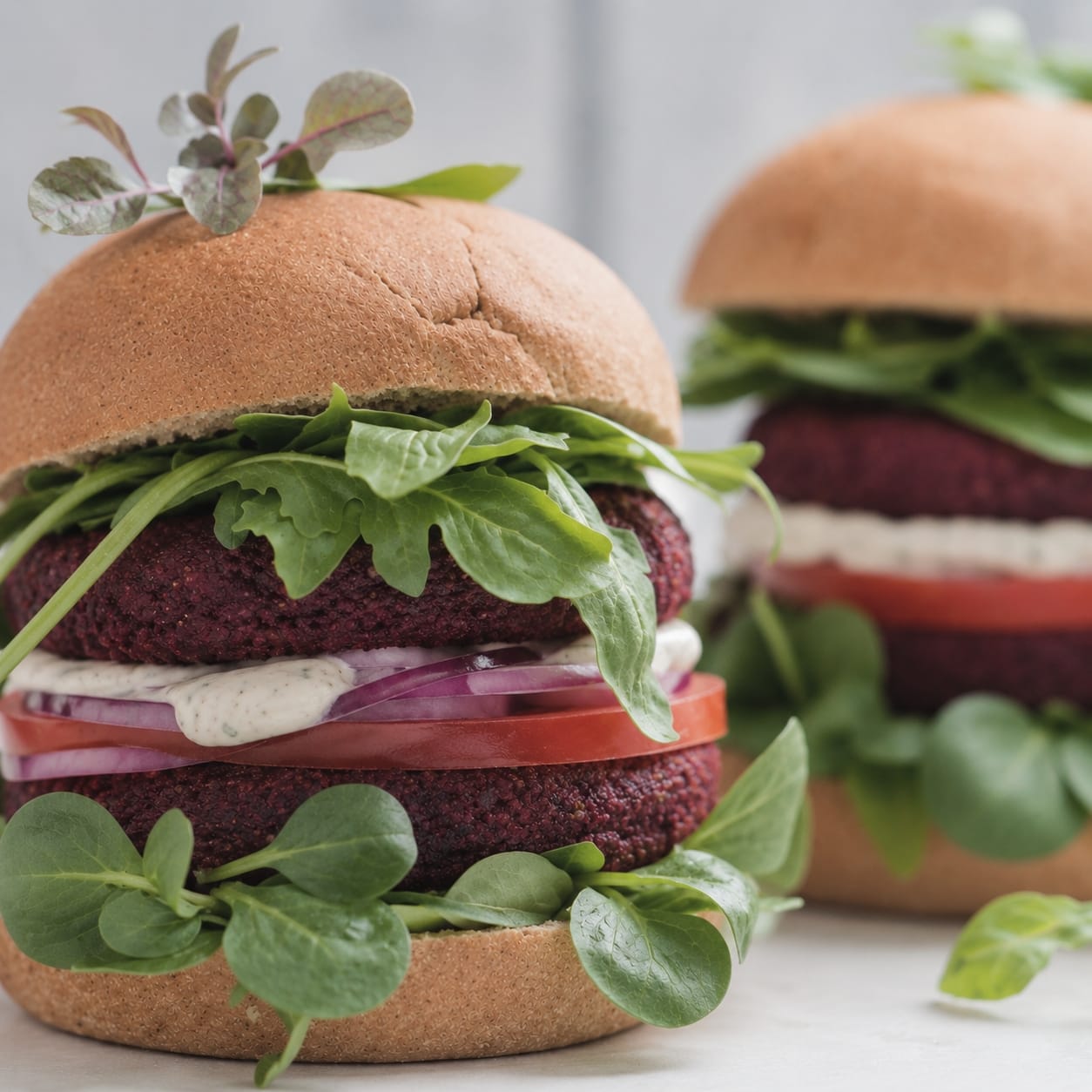 Double hamburger with leafy greens in the bun