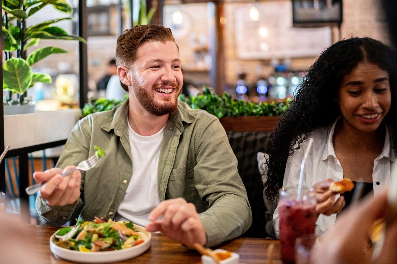 Friends enjoying a meal together at a restaurant.