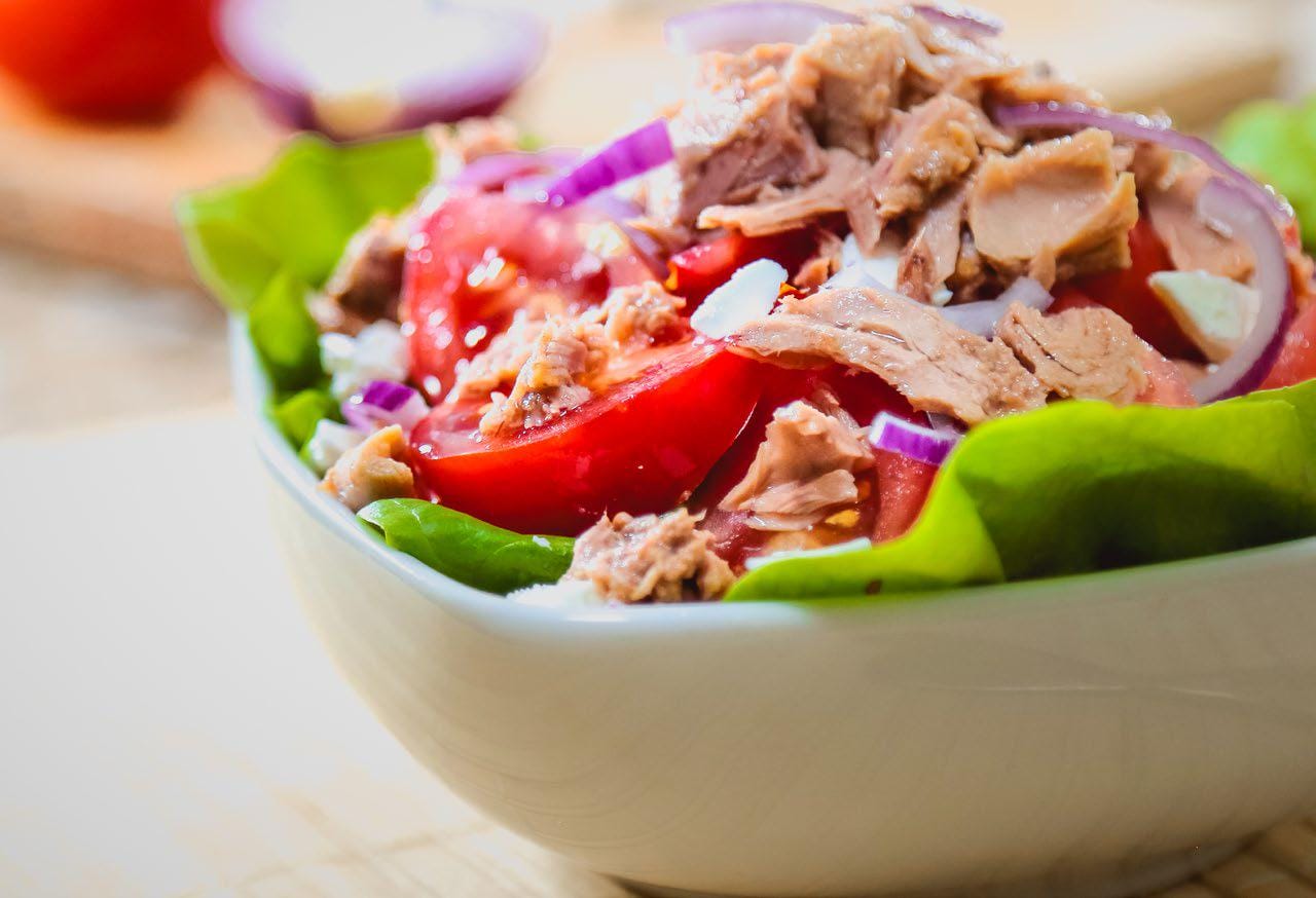 Meditteranean tuna salad in a white bowl on a light counter