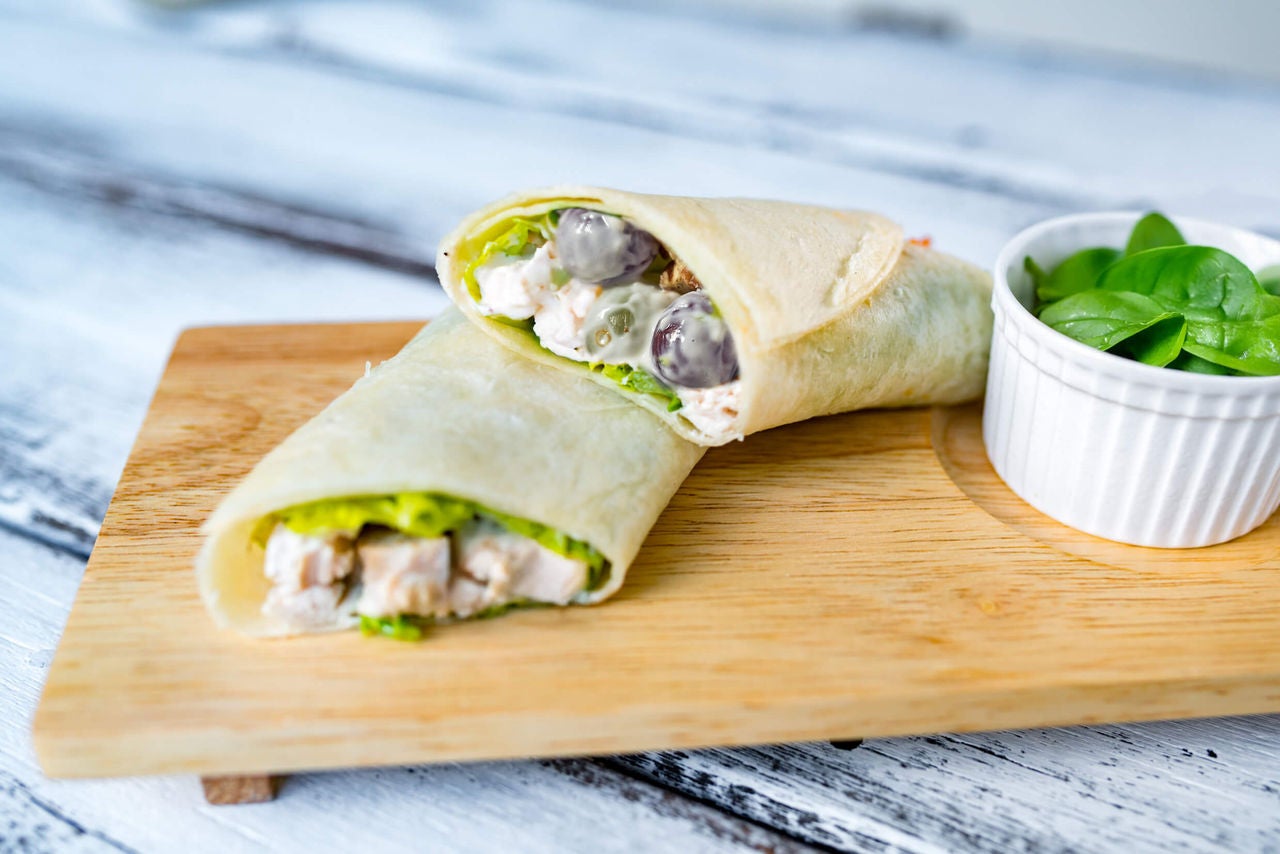 Wrap with chicken, grapes and walnuts in a creamy sauce and side of spinach.