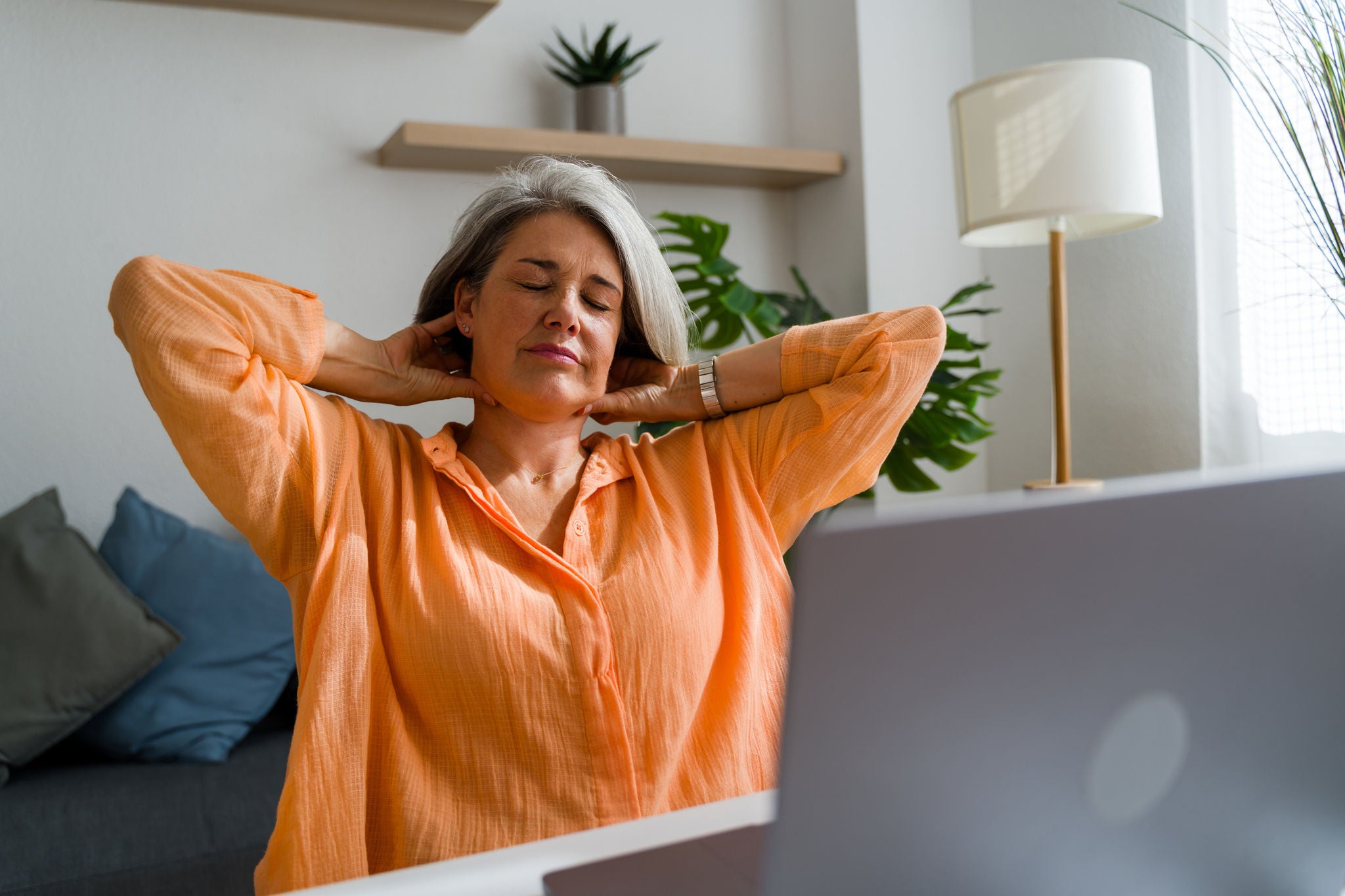 A woman stretching her neck and back