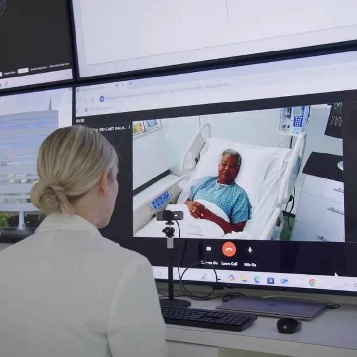 Nurse observing a patient on video monitor