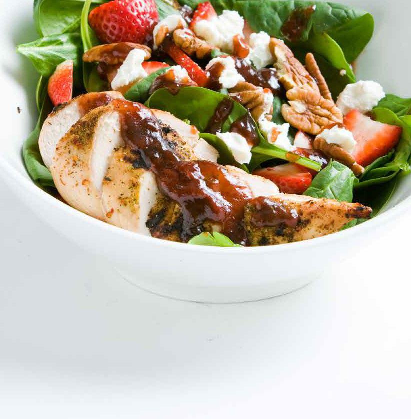 Spinach salad with chicken, strawberries, walnuts, and feta cheese
