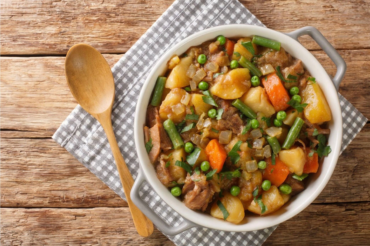 Pot with beef, potatoes, rutabaga, carrots, peas and green beans.