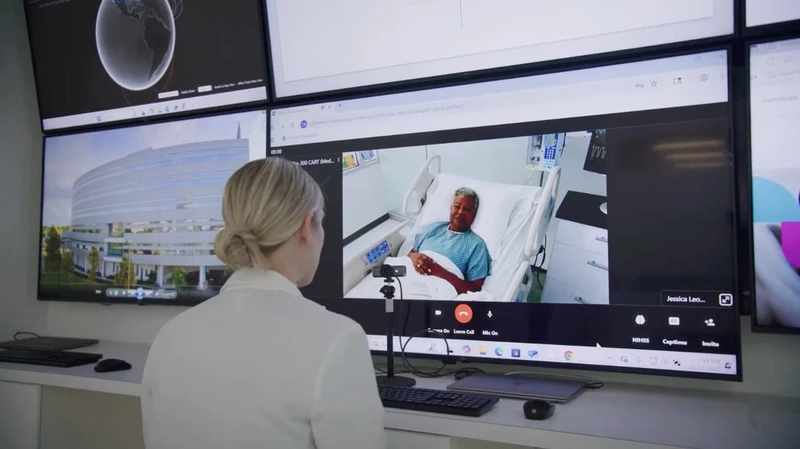 Nurse sitting watching a patient through a monitor