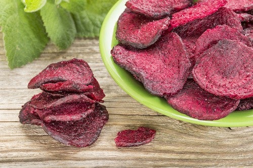 red beet chips in a green bowl - a healthy vegetable snack