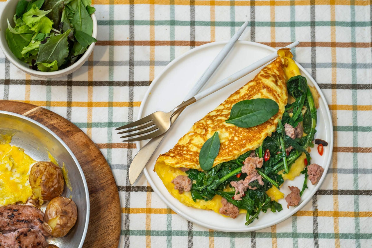 Omelet with sausage, spinach and potato.