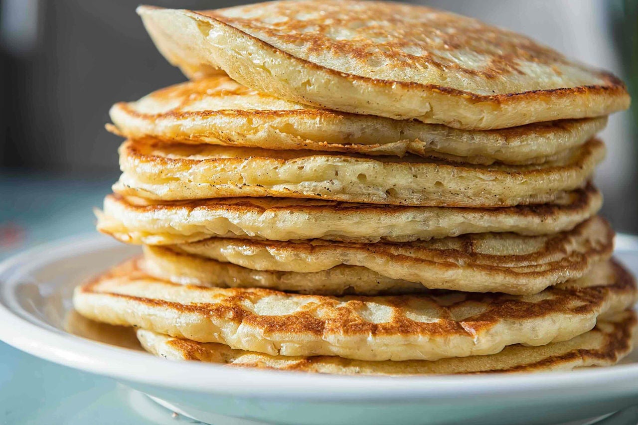 Stack of plain pancakes on a plate.
