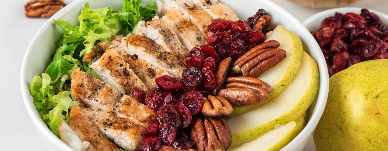 Pear cranberry salad with chicken in a bowl