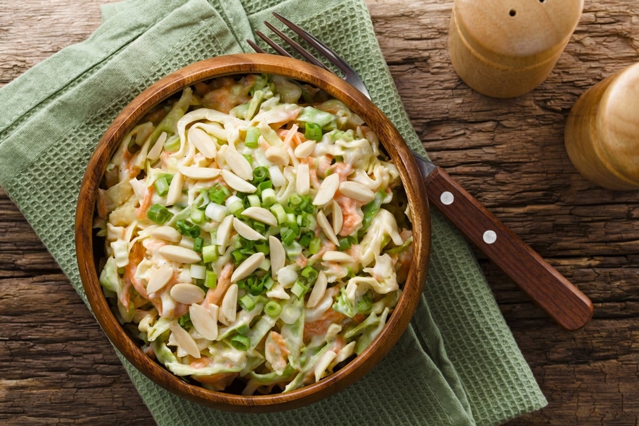 Bowl with slaw salad and shredded salmon.