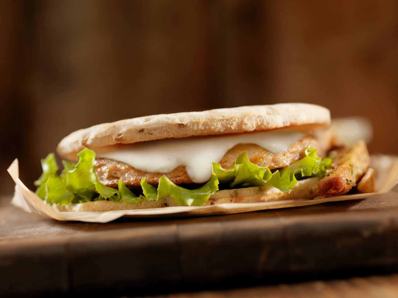 Turkey burger on thin buns with lettuce and blue cheese dressing. 
