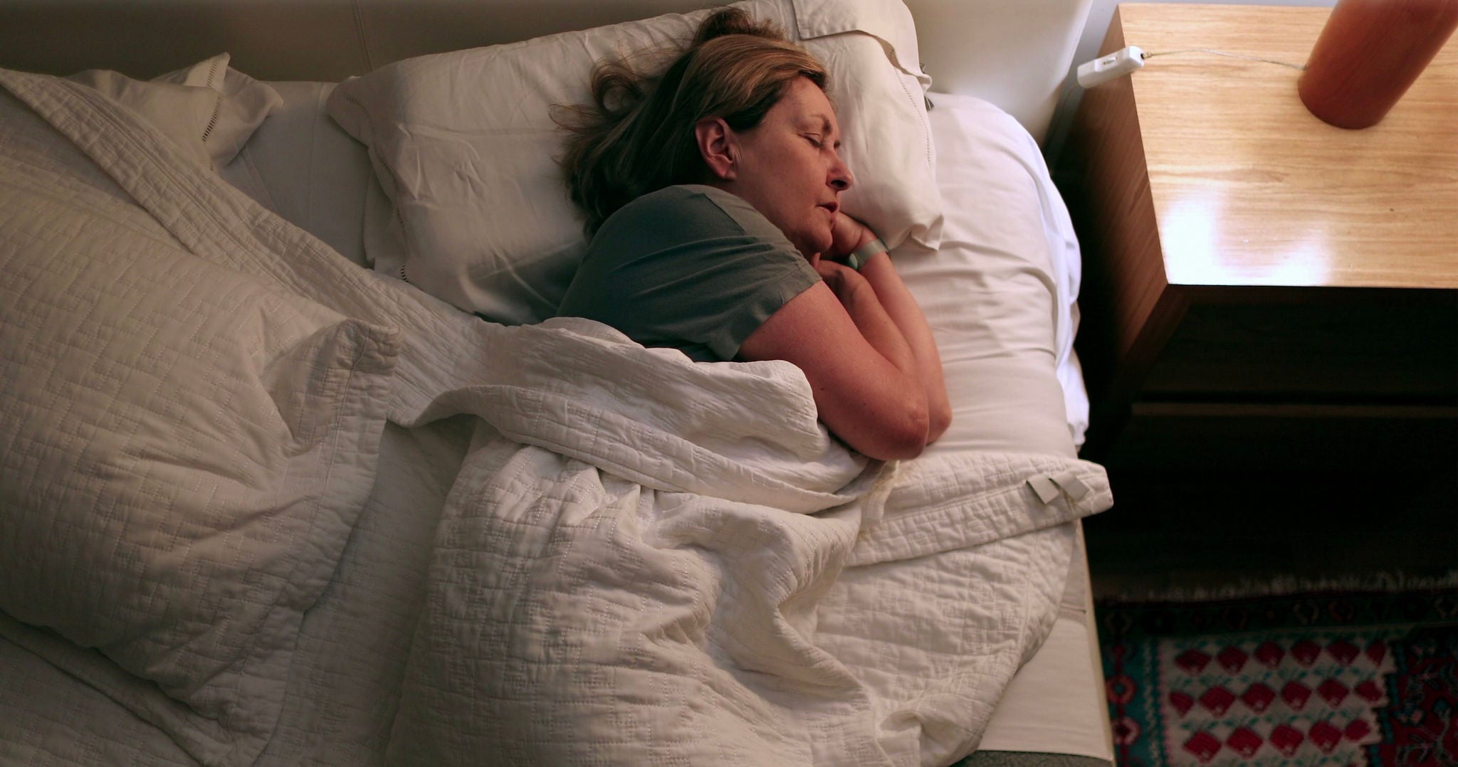 Older woman sleeping in bed.