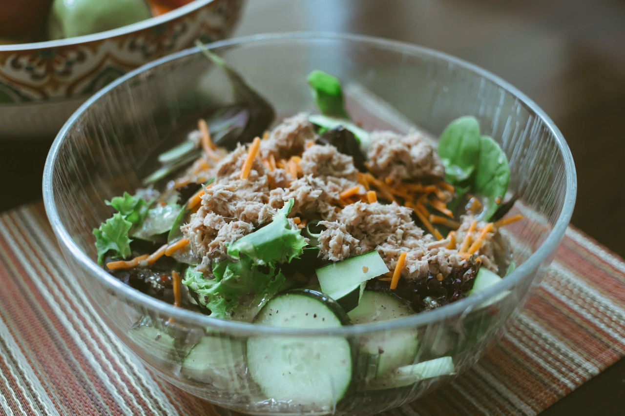 Bowl of mixed greens and canned tuna.