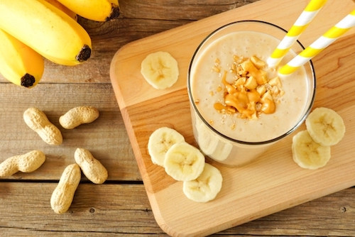 Peanut Butter Banana Smoothie in Glass Cup with Yellow Straw 