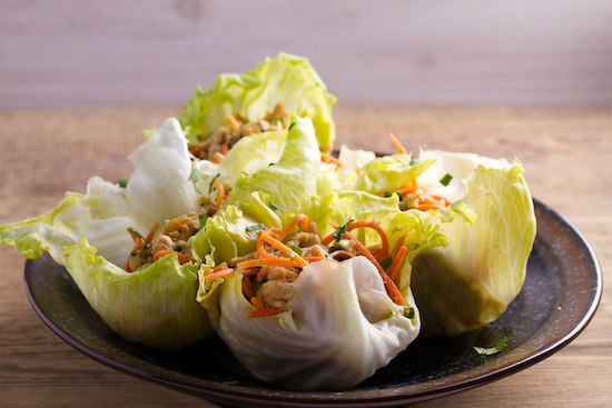 Chicken Lettuce Wraps on Brown Plate on Wood Cutting Board