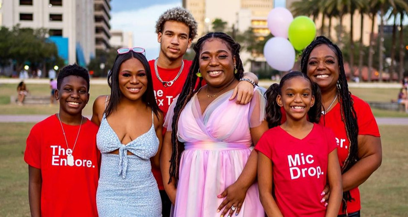 A family photo of Kristy and her kids enjoying time together in a park.