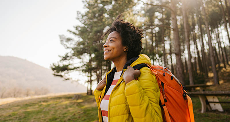 A woman smiling while she is hiking