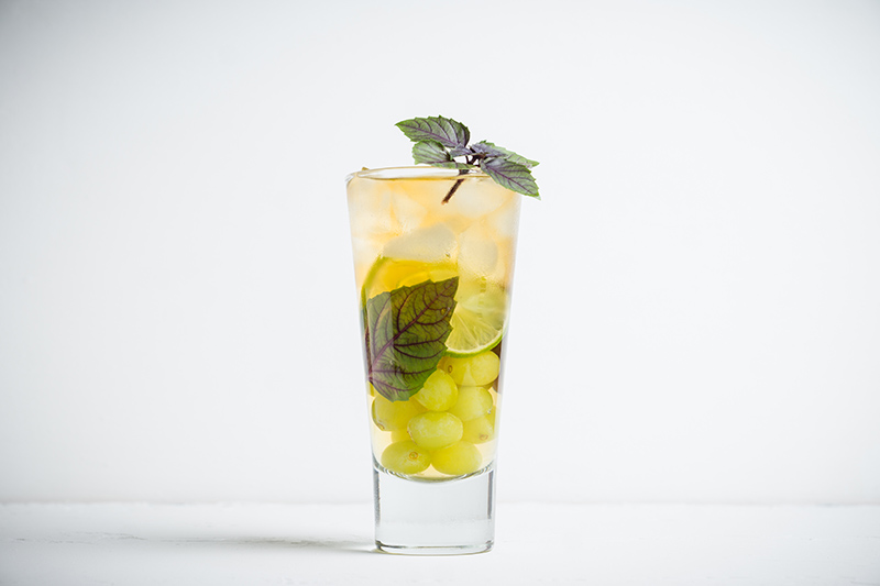 Fresh drink made with grape, lime and basil leaves.