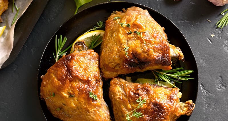 Baked lemon pepper chicken thighs on a plate