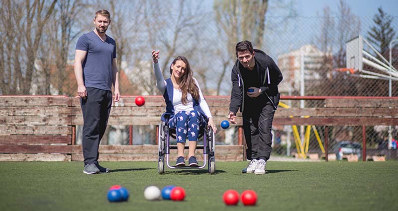 A group of 3 friends playing bocce together