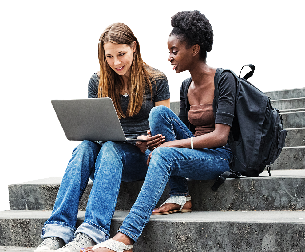 Two female college students sitting on stairs with a laptop
