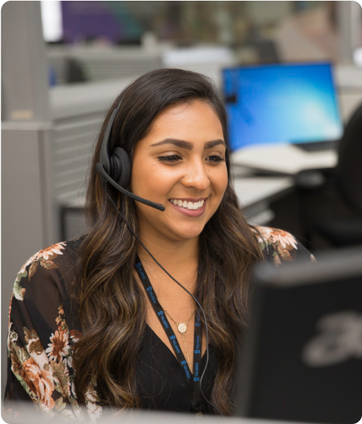 Woman with headset looking at computer 