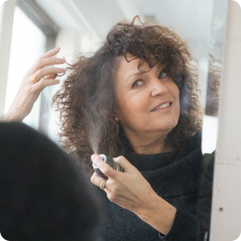 woman spraying hair