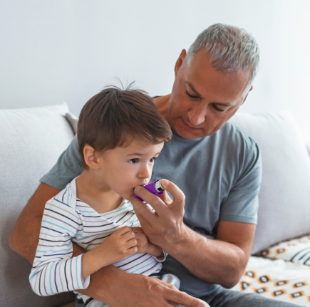  Father holding child on lap on couch
