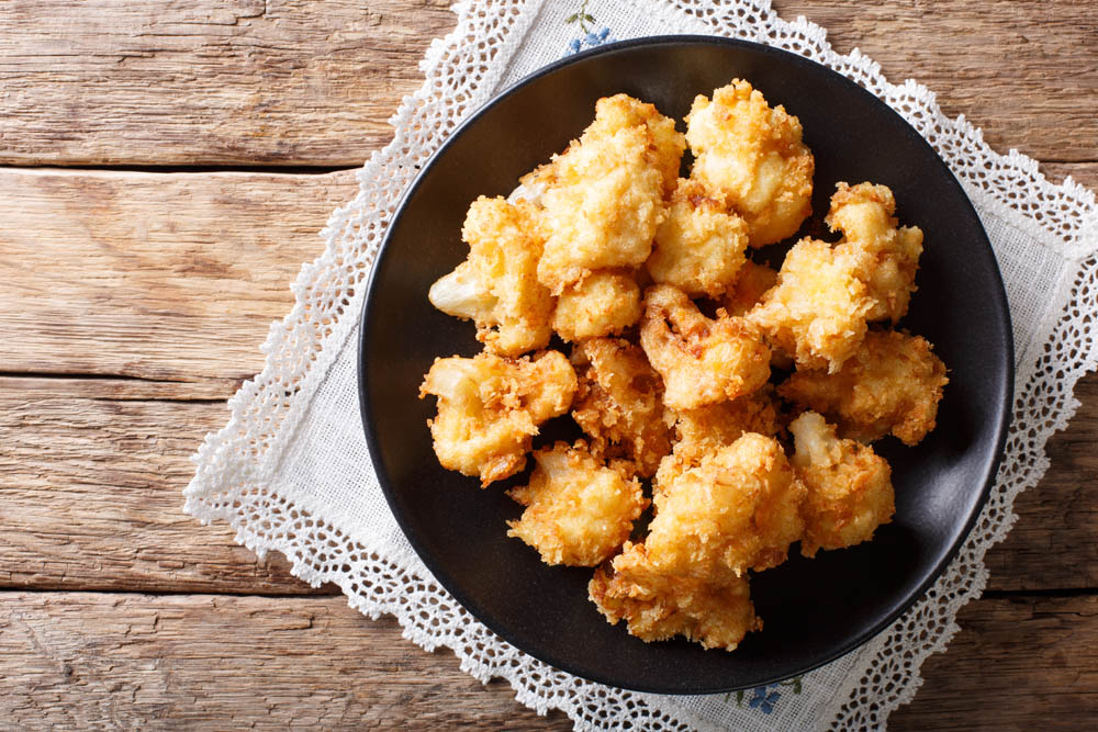 fried fresh cauliflower in breadcrumbs closeup. horizontal top view