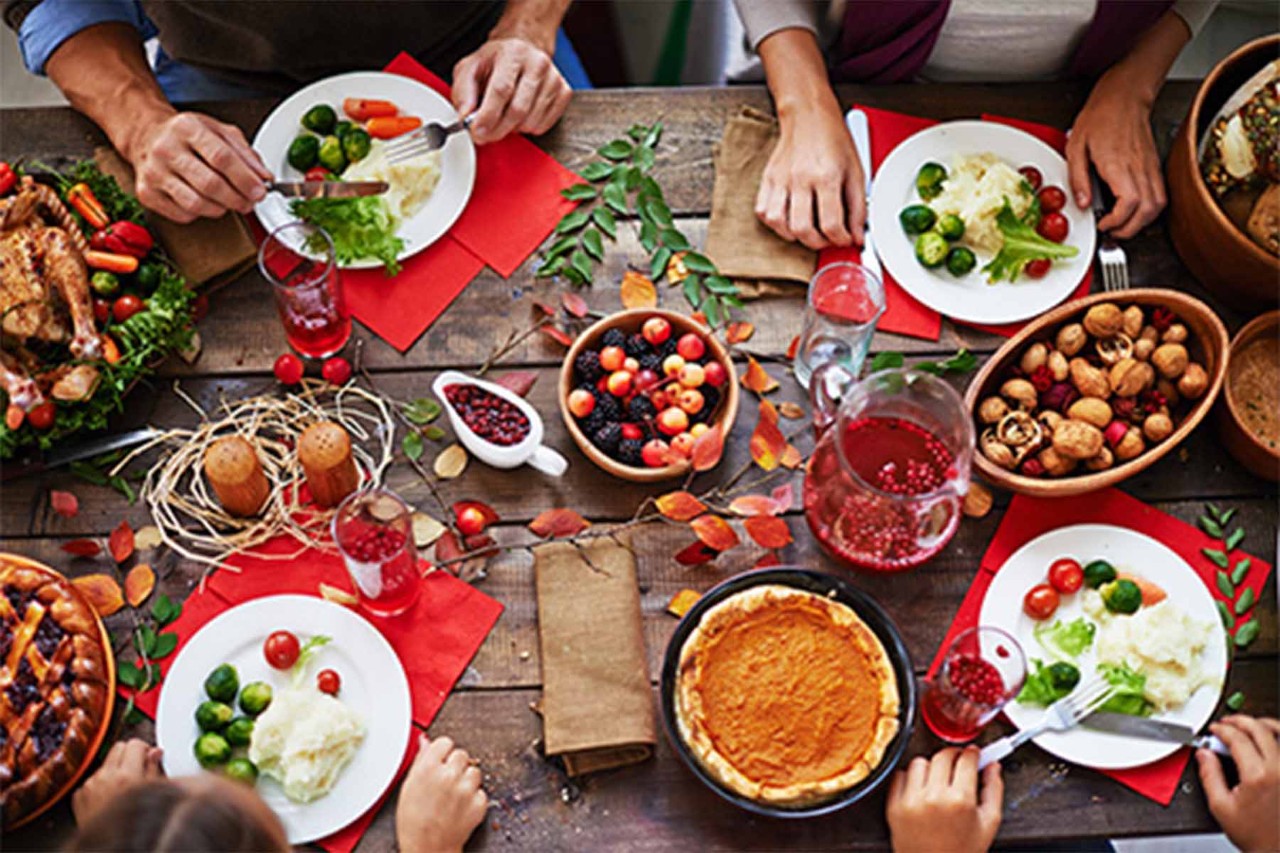 Festive dinner with vegetables, berries, nuts, and pumpkin pie.