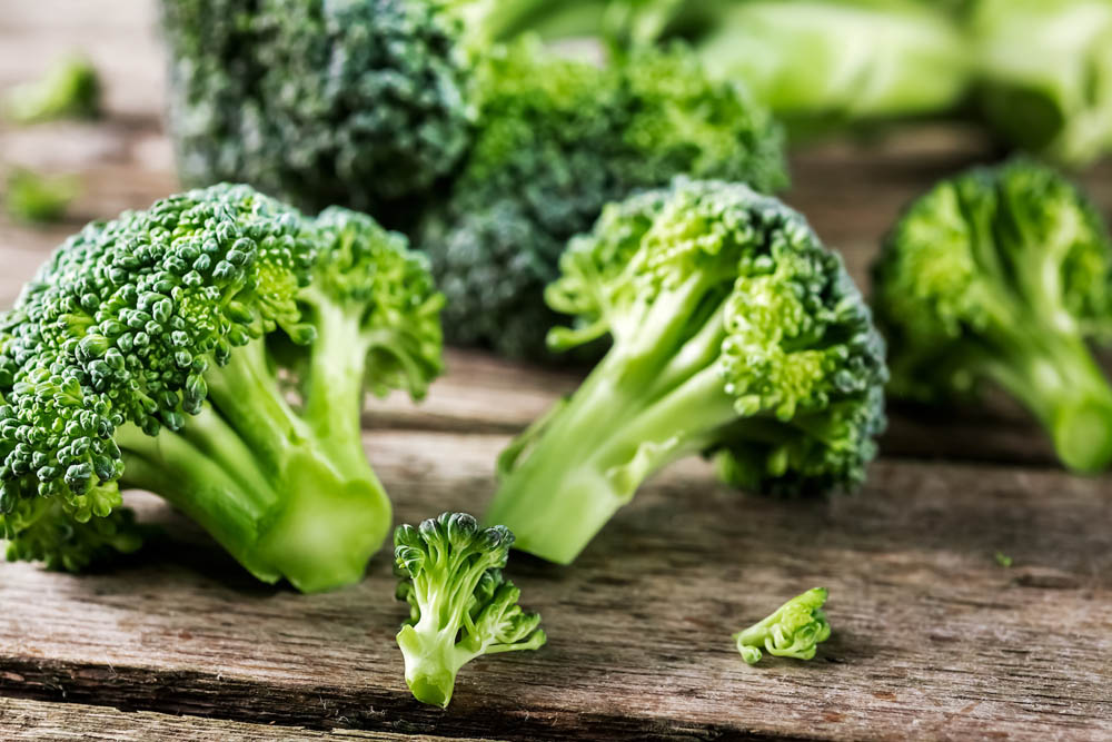 Pieces of broccoli, rustic style, old wooden background