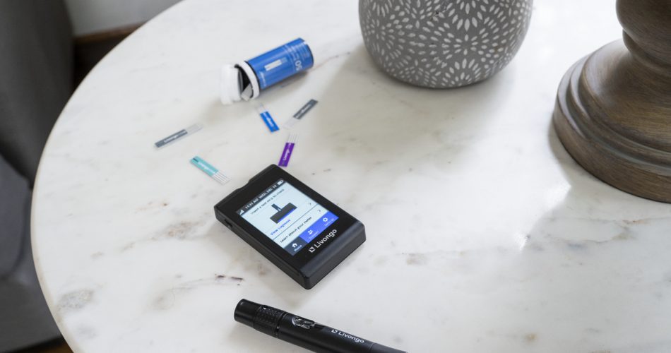 Blood glucose meter and strips on a table