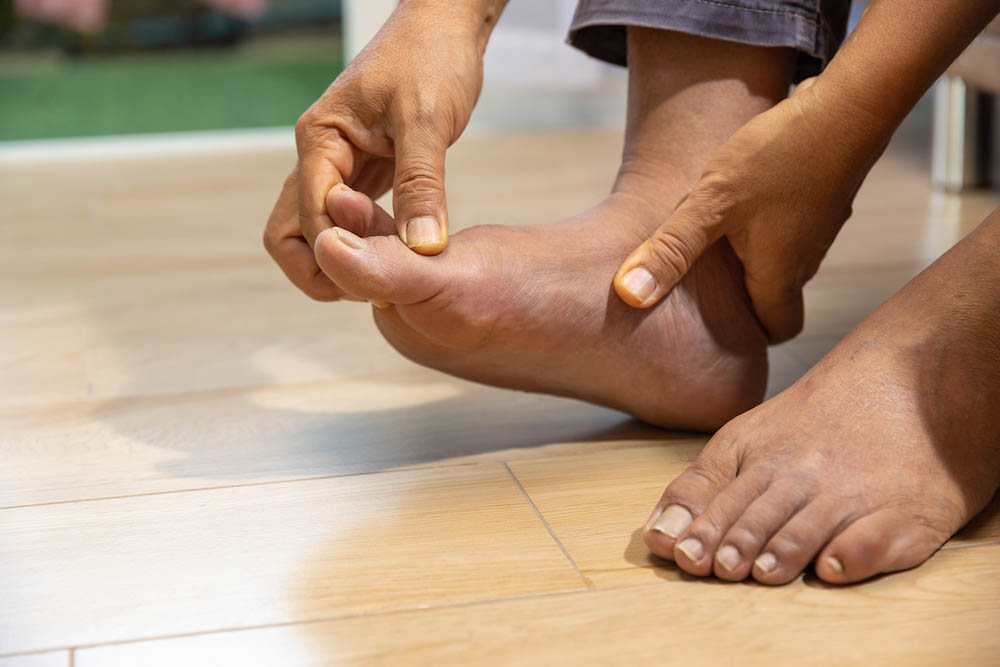 Senior Man massage foot with painful swollen gout inflammation
