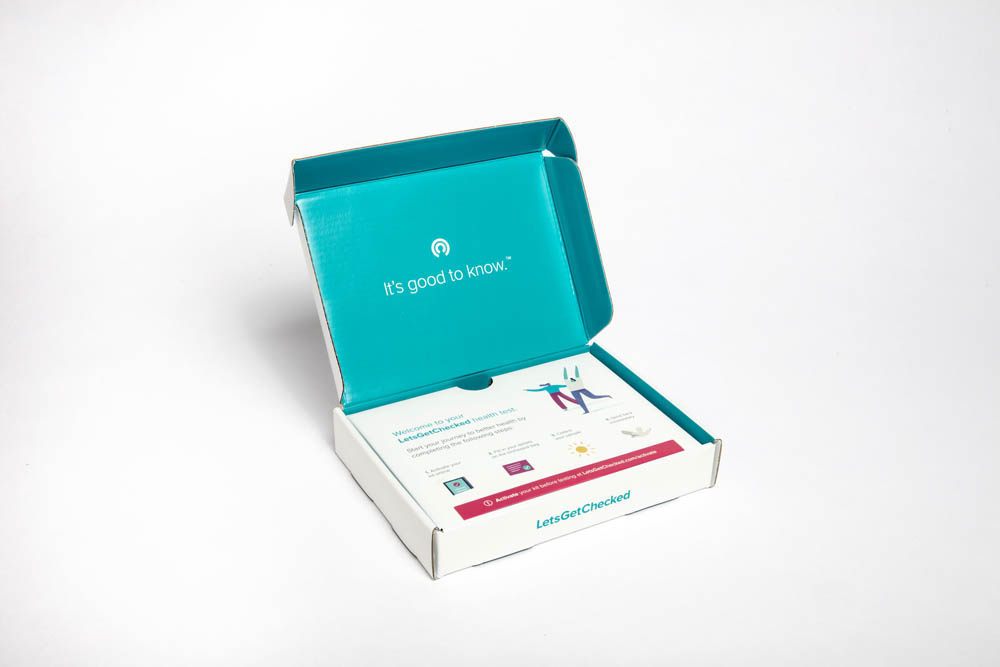 An open box of a health-related product, featuring a teal lid and various printed materials inside, displayed against a neutral background.