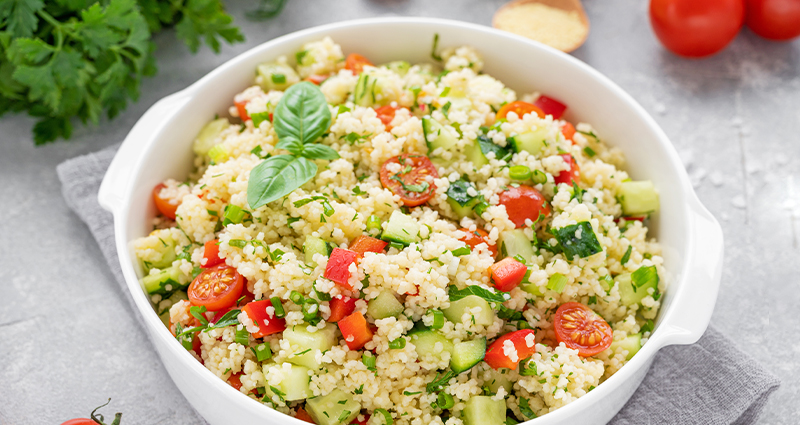 couscous salad in a white bowl