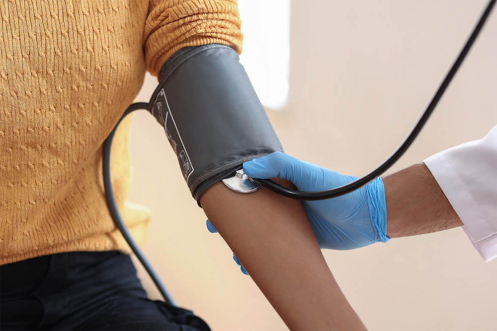 Healthcare professional measuring a patient's blood pressure.