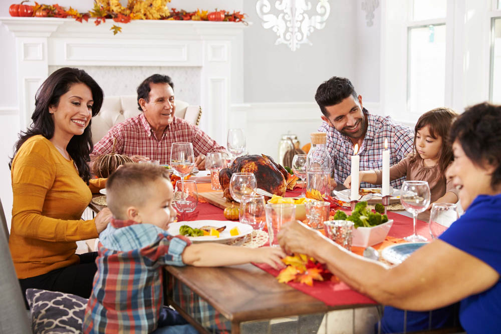 Family gathered around a festive dinner table, sharing a meal and laughter.