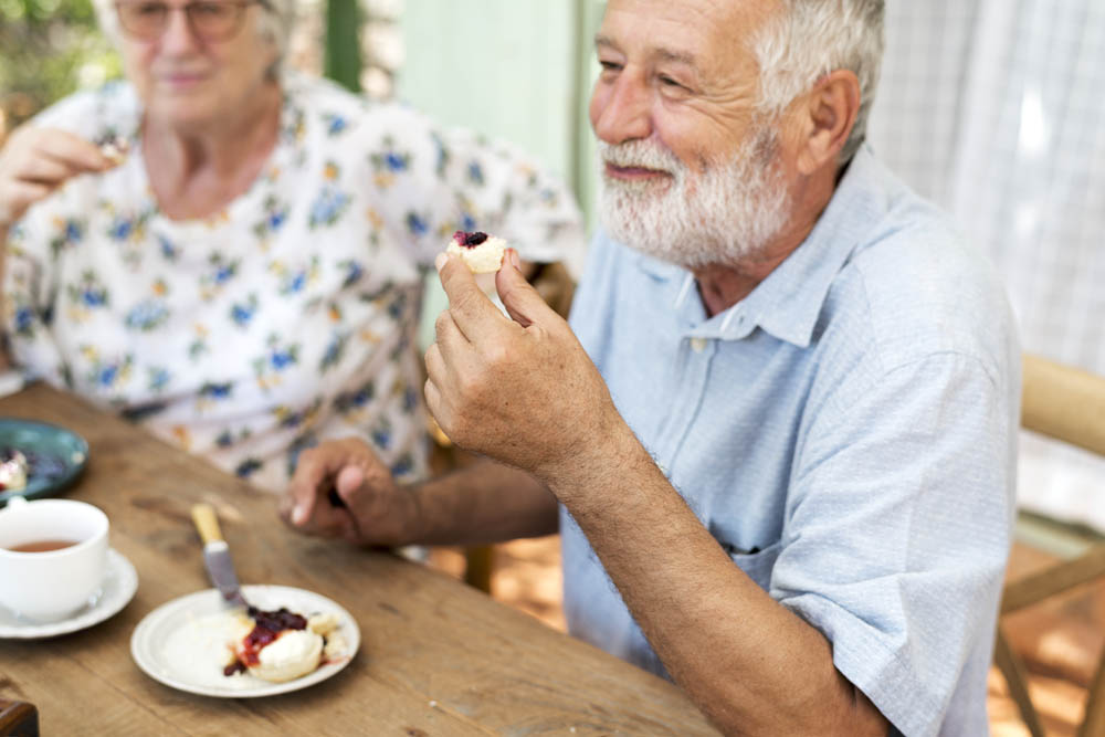 Old couple having scones for tea
