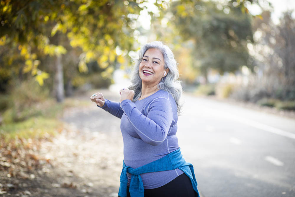 A senior woman stretching her legs