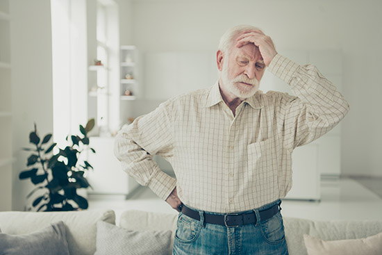 Close up photo of grey haired he his him granddad with alone in big house miss grandchildren wearing casual checkered shirt jeans denim outfit sitting comfy on divan