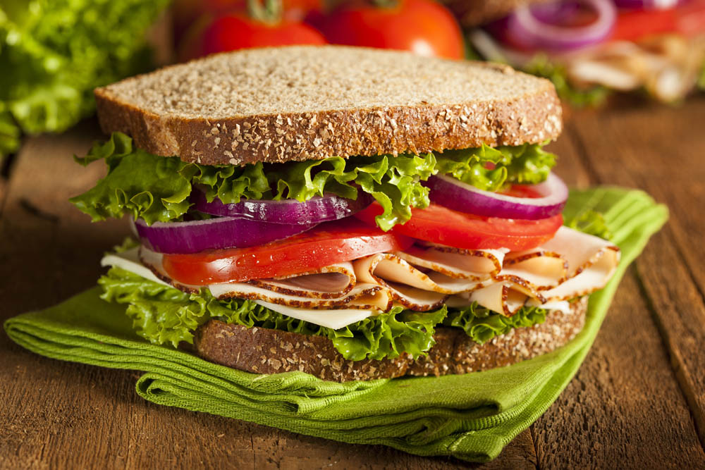 Homemade Turkey Sandwich with Lettuce, Tomato, and Onion