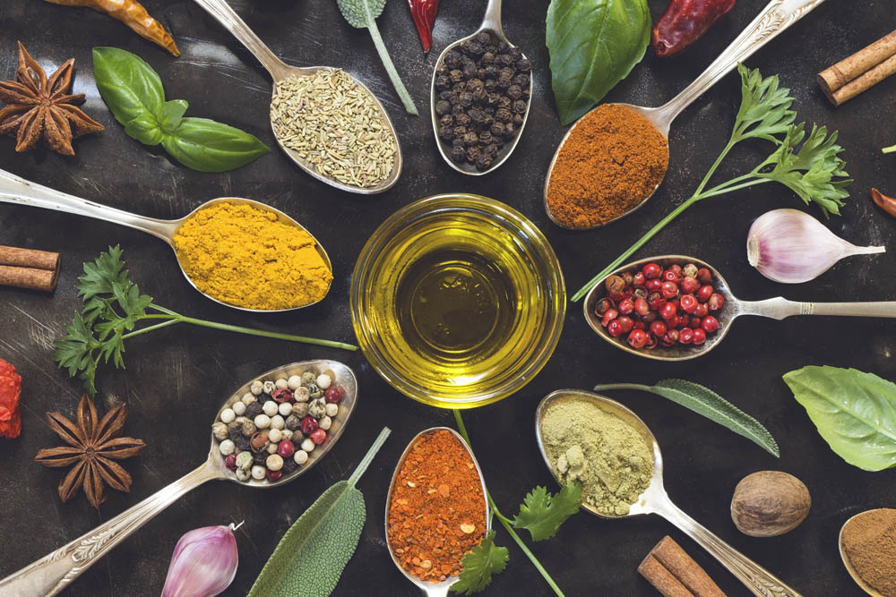 Various herbs and spices on black background