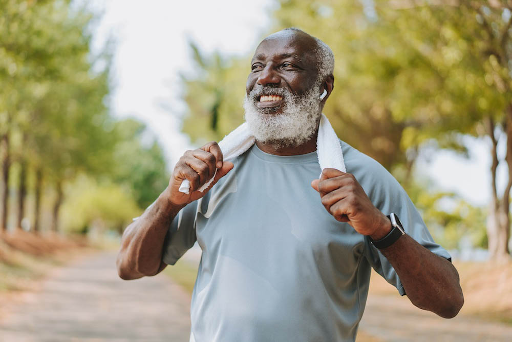 Portrait of a senior man exercising with a towel around his neck