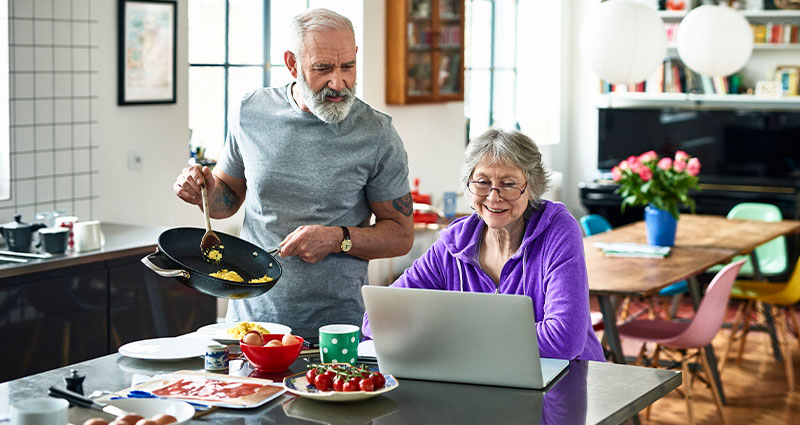 Older couple reading while eating