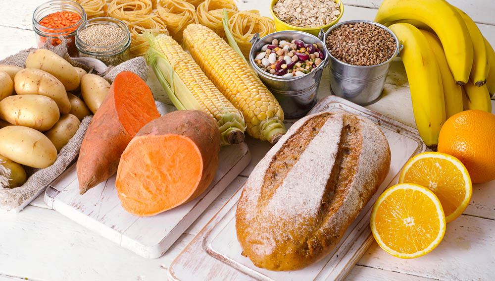 Products rich of carbohydrates. Healthy eating on white wooden table.