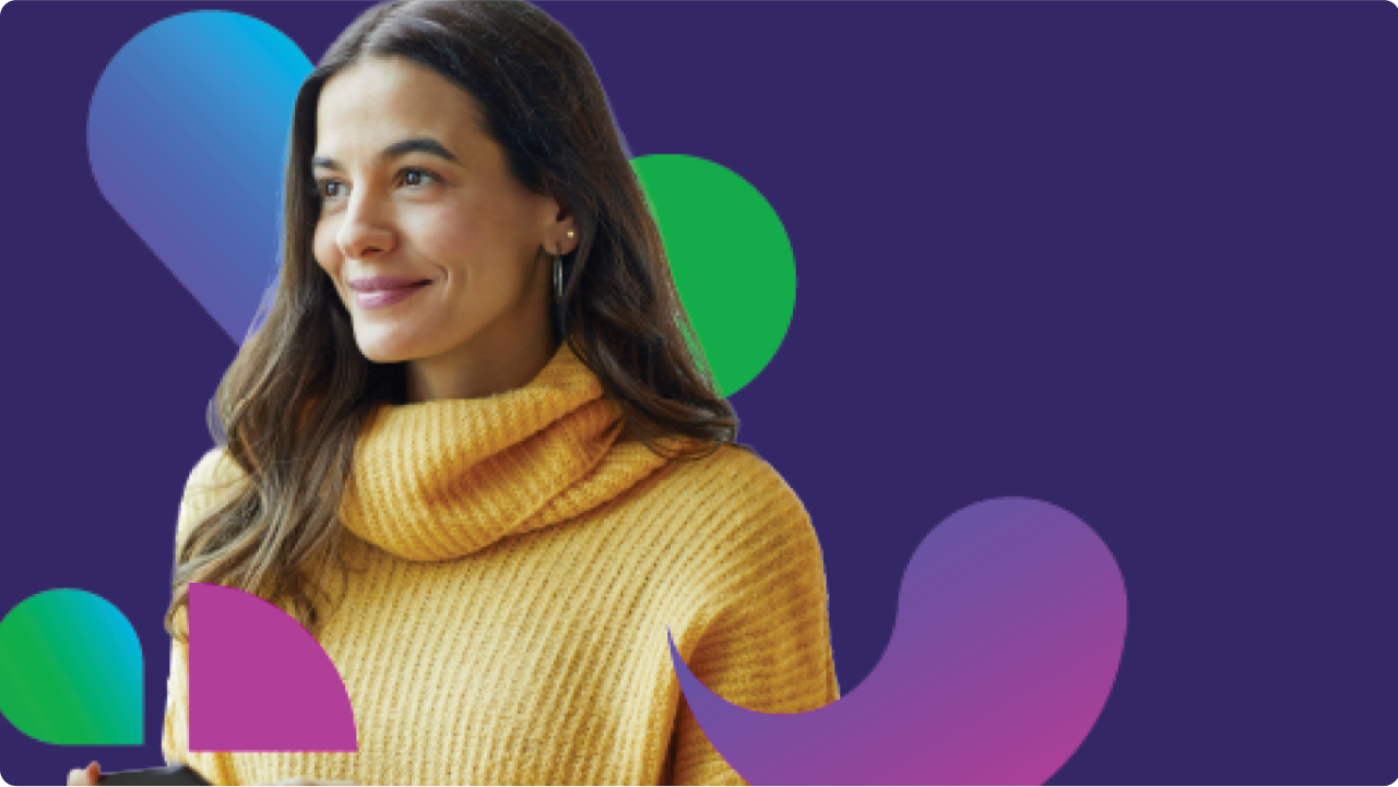 Woman smiling in gold sweater with different color pavers and purple in the background